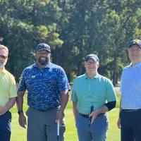 Four alums at the golf tournament.